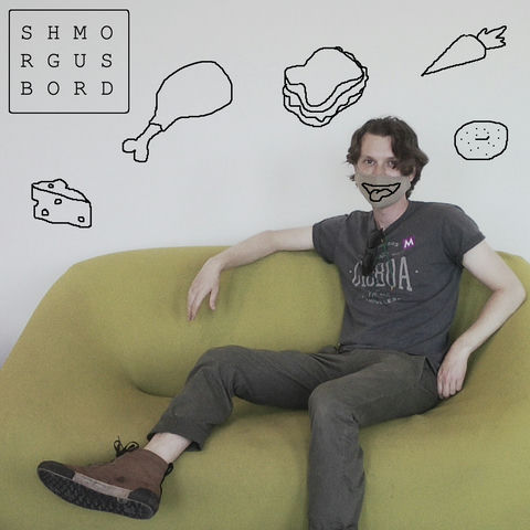 Roldy on a green sofa wearing a mask, with crude microsoft paint drawings of food.